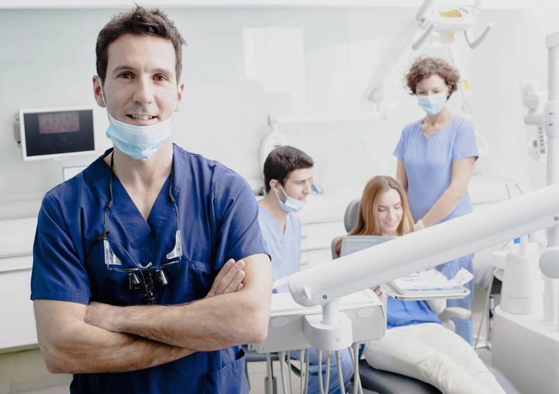 A dentist and his team in the dental office.